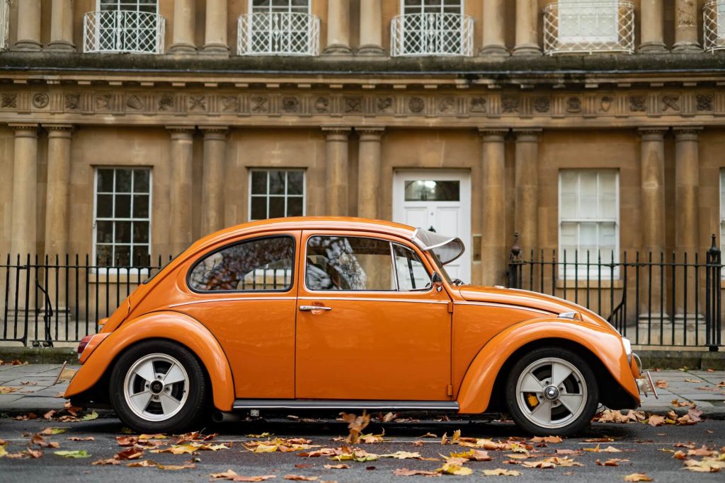 Volkswagen Beetle, a compact car with iconic round shape.
